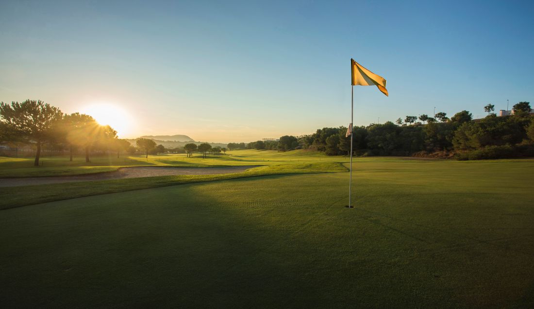 Yellow flag on the putting green at Alenda Golf Club in Spain