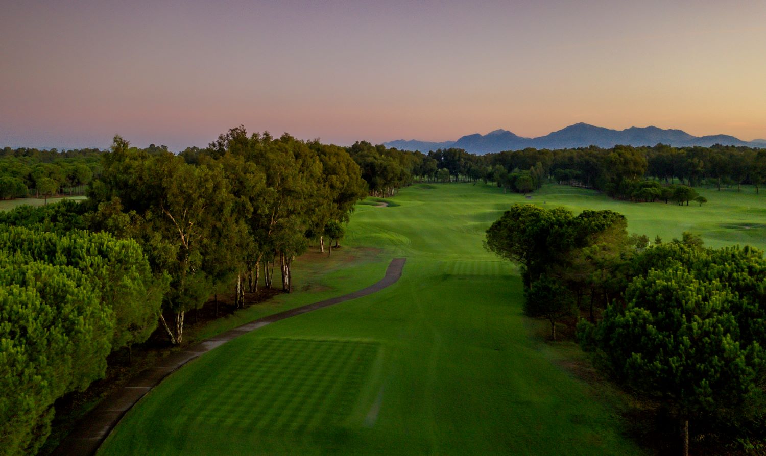 Fairway with trees lining it at Antalya Golf Club in Belek