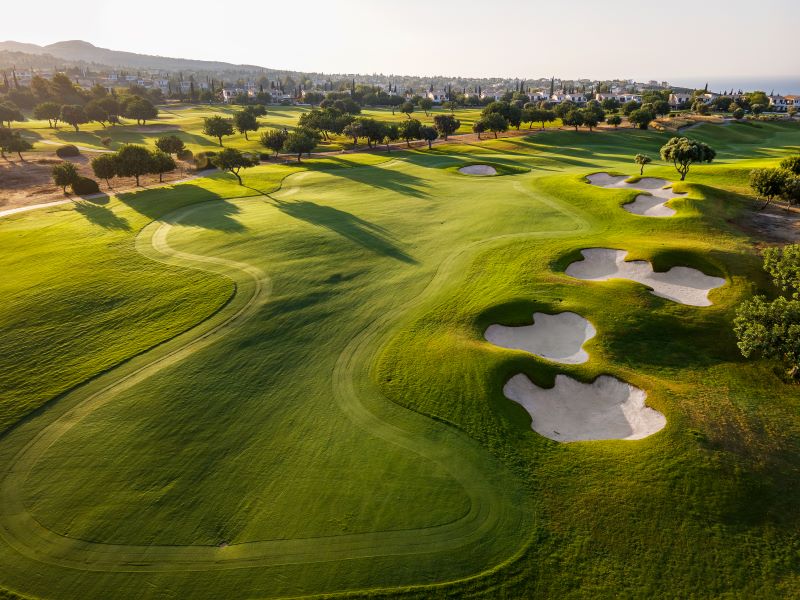 Fairway of Aphrodite Hills Golf Course with green trees protecting the fairway