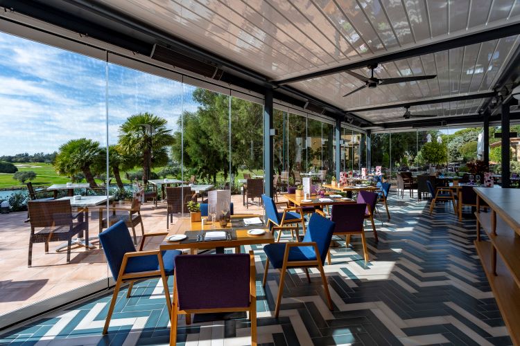 Tables and chairs in seating area at Barcelo Montecastillo Golf Resort