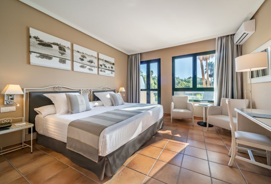 Bedroom at Barcelo Montecastillo Golf Resort with double bed and tiled floor