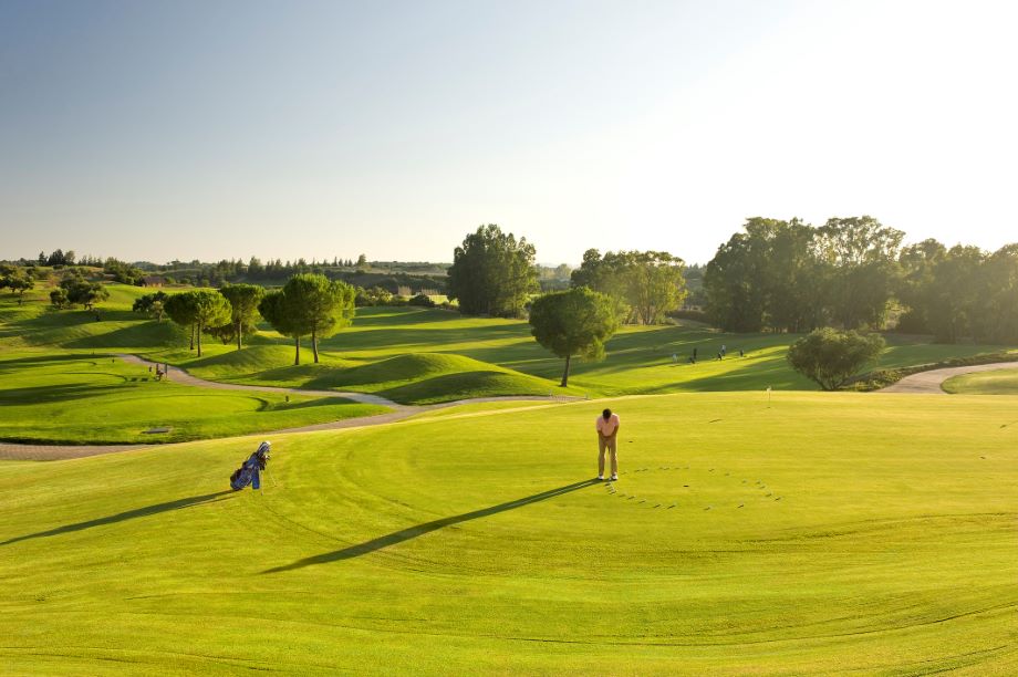 Golfer on the putting green at Montecastillo golf course