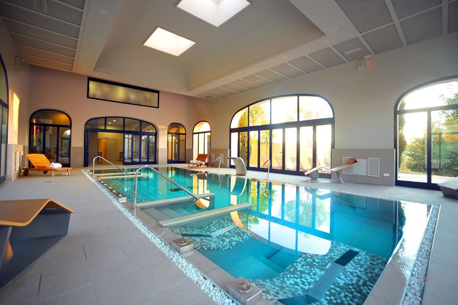 Indoor swimming pool with large glass window at Barcelo Montecastillo Golf Resort
