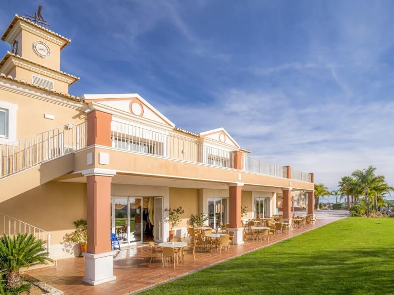 Club house at Boavista golf course with patio seating