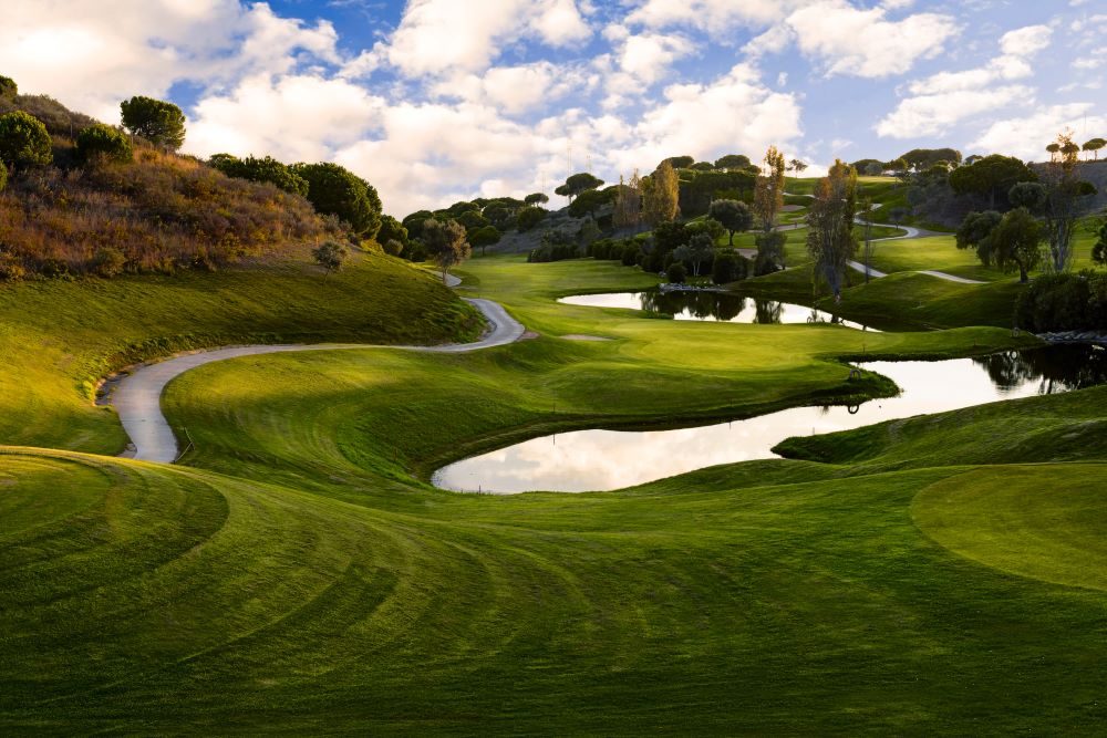 White sand bunker with green trees at Cabopino Golf in Marbella, Costa Del Sol