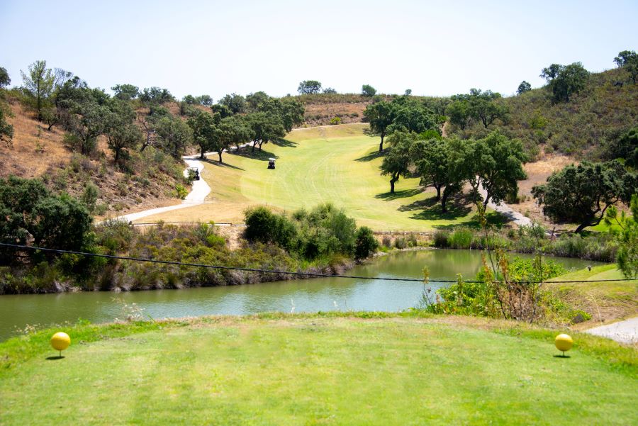 Tee with water in front and fairway in distance at Castro Marim Golf & Country Club