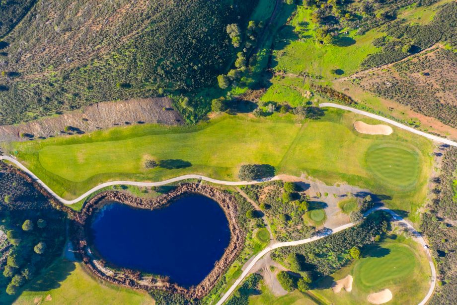 Overhead of the golf course, with blue lake directly below at Castro Marim
