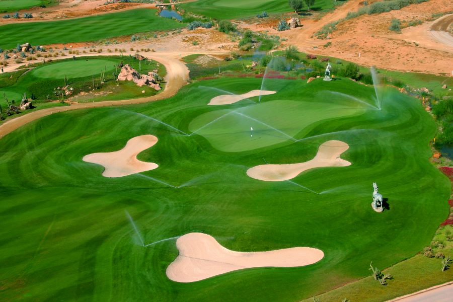 Arial shot of Desert Springs Golf Course in Spain with sprinklers watering the green