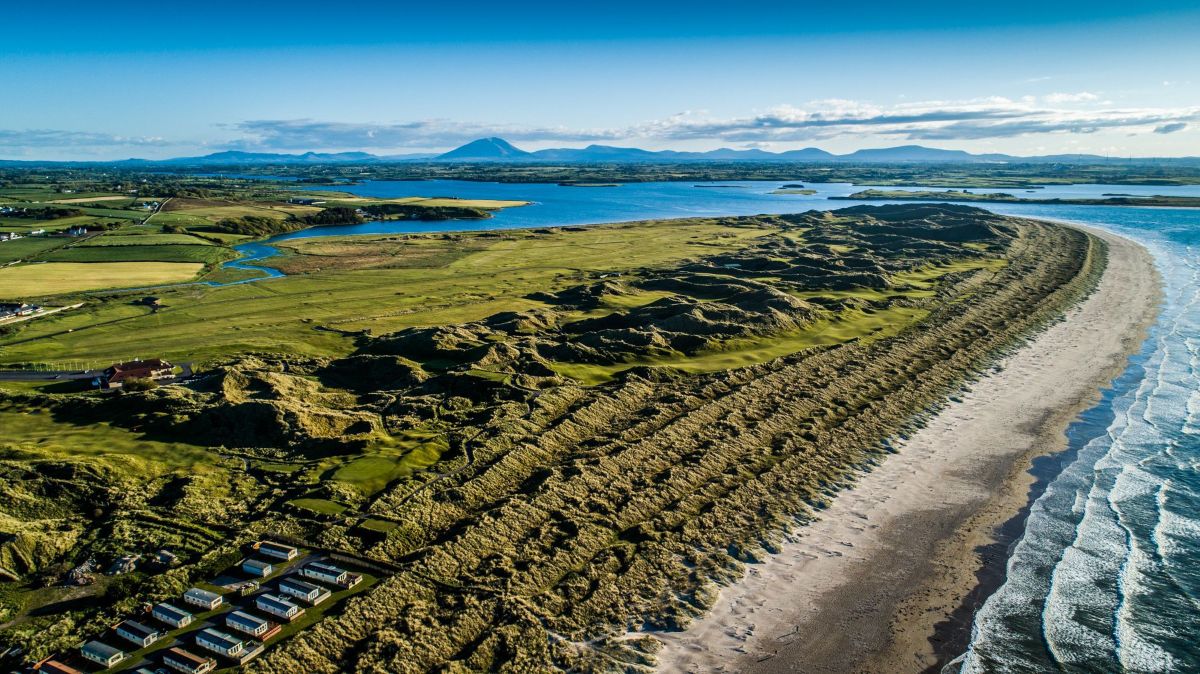Enniscrone Golf Club with the coast lapping up against it, and lodges in the foreground