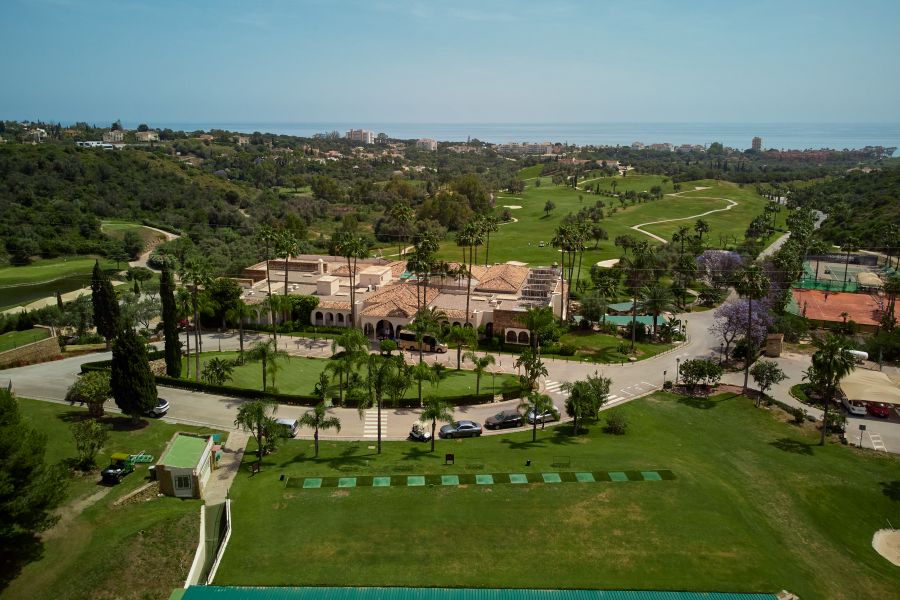 Clubhouse with practice facilities at Higuerón Marbella Golf Resort
