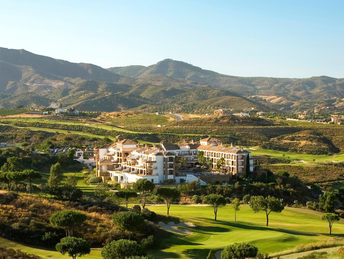 Ariel photo of La Cala Golf Resort surrounded by golf courses with Sierra de Mijas in the background