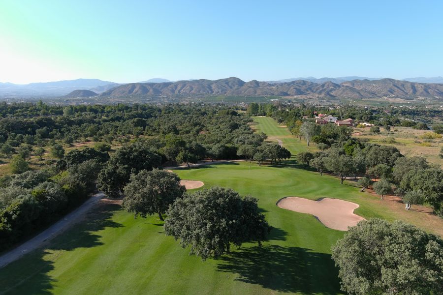 Sand bunker behind the trees at Lauro Golf Course in Costa Del Sol, Spain