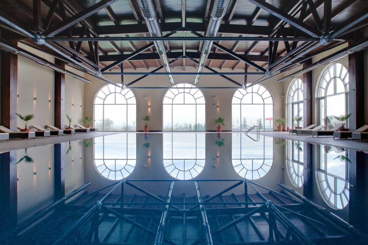 Lighthouse Golf and Spa Hotel's heated indoor swimming pool with sun loungers and plants