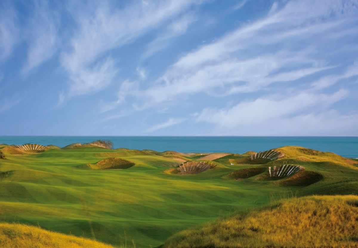 Blue sky with white clouds over the course with blue sea in the distance at Lykia Links Golf Club