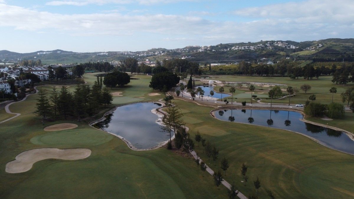 Blue lakes and green trees on various holes at Mijas Golf Club in Spain