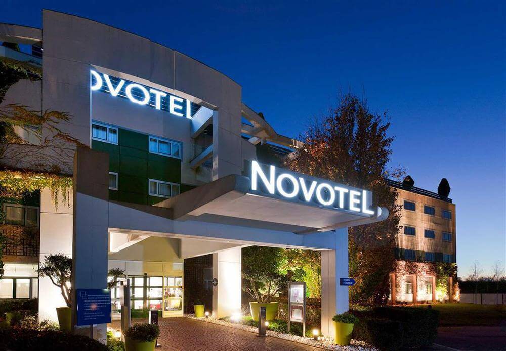 Novotel Saint Quentin Golf National illuminated entrance at night