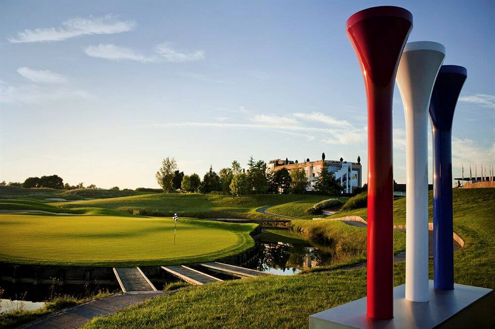 Novotel Saint Quentin Golf National overlooking the lake and putting green with giant tee sculpture