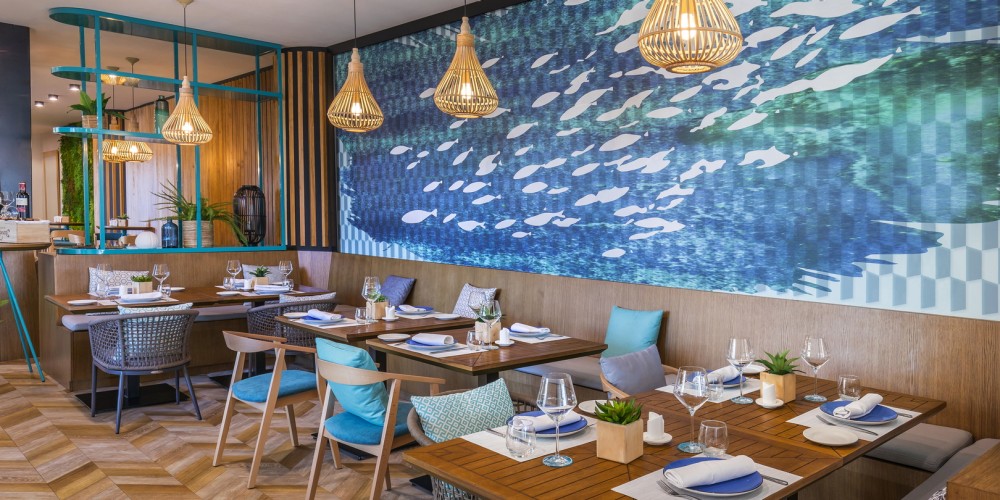 Restaurant in Occidental Puerto Banus with sea theme and wooden tables and chairs
