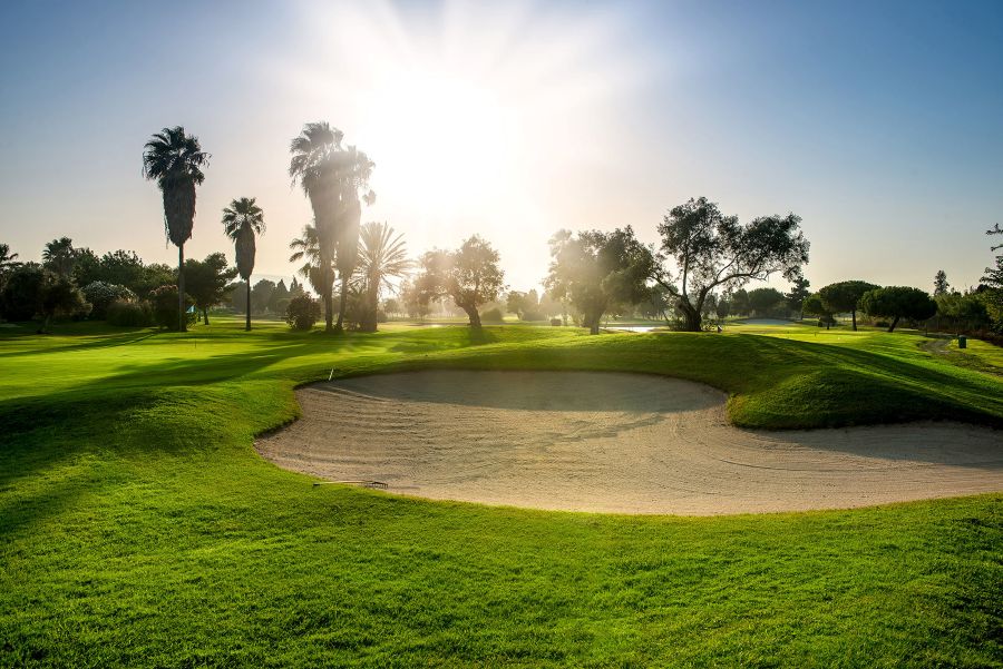 Sun coming through the cloud over the golf course at Oliva Nova golf course in Denia