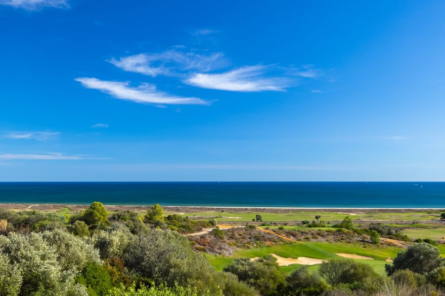 Clouds in front of blue sky and deep blue sea overlooking the golf course in the Algarve's Palmares Ocean and Living Golf Club