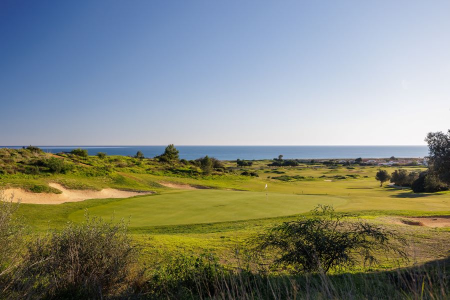 View across the fairway towards the blue sea at Palmares Ocean and Living Golf Club