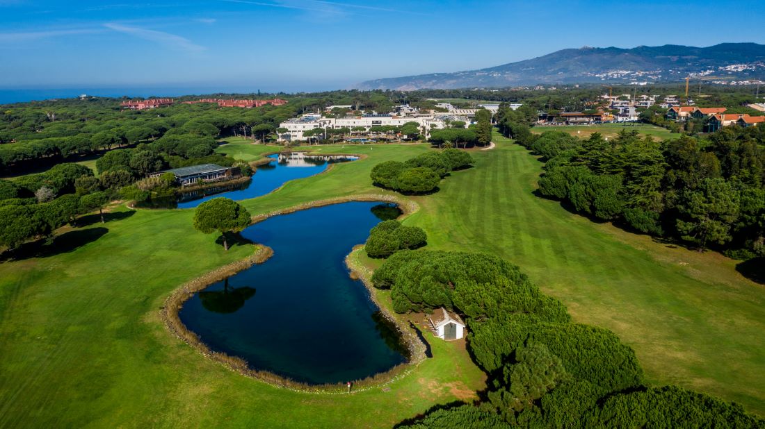 Quinta Da Marinha golf course with the hotel and resort in the background, and blue lake and green fairways in foreground