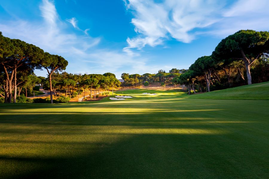 View down the fairway with green trees protecting the green at Quinta Do Lago North course