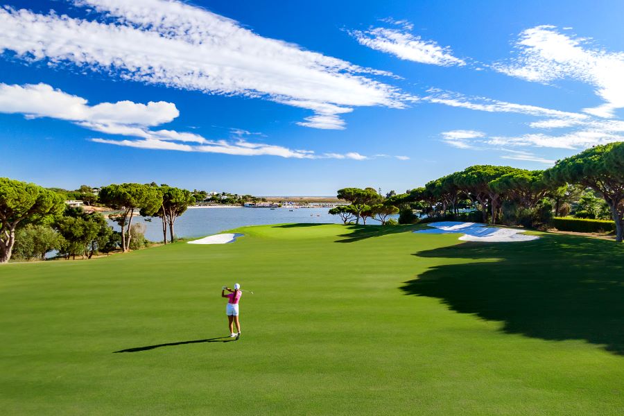 Quinta Do Lago Golf Course with golfer on the fairway hitting a shot towards the green