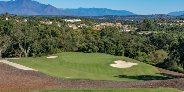 San Roque Golf Old Course in Costa Del Sol, Spain with houses behind trees in the distance