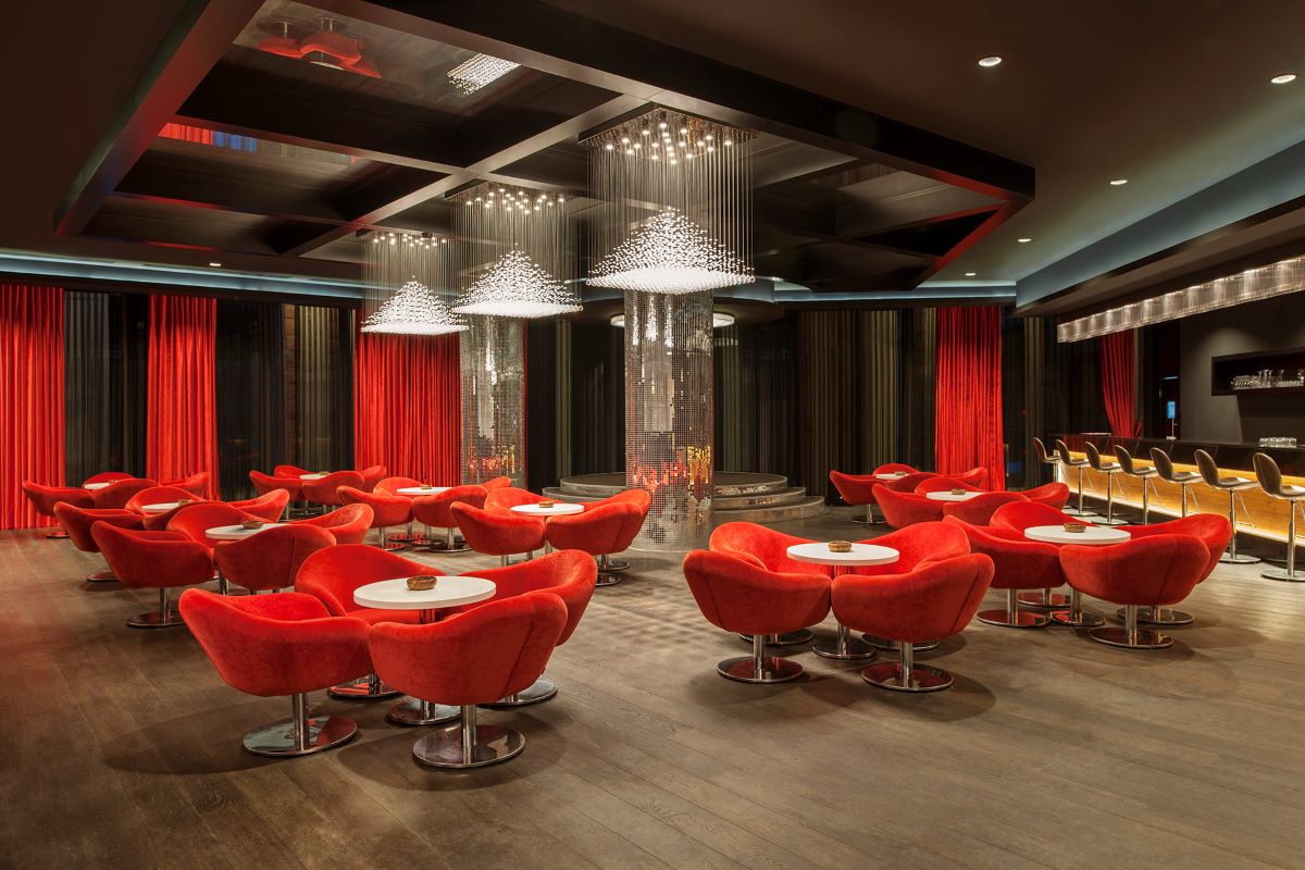 Red chairs in bar area at Sirene Golf Resort