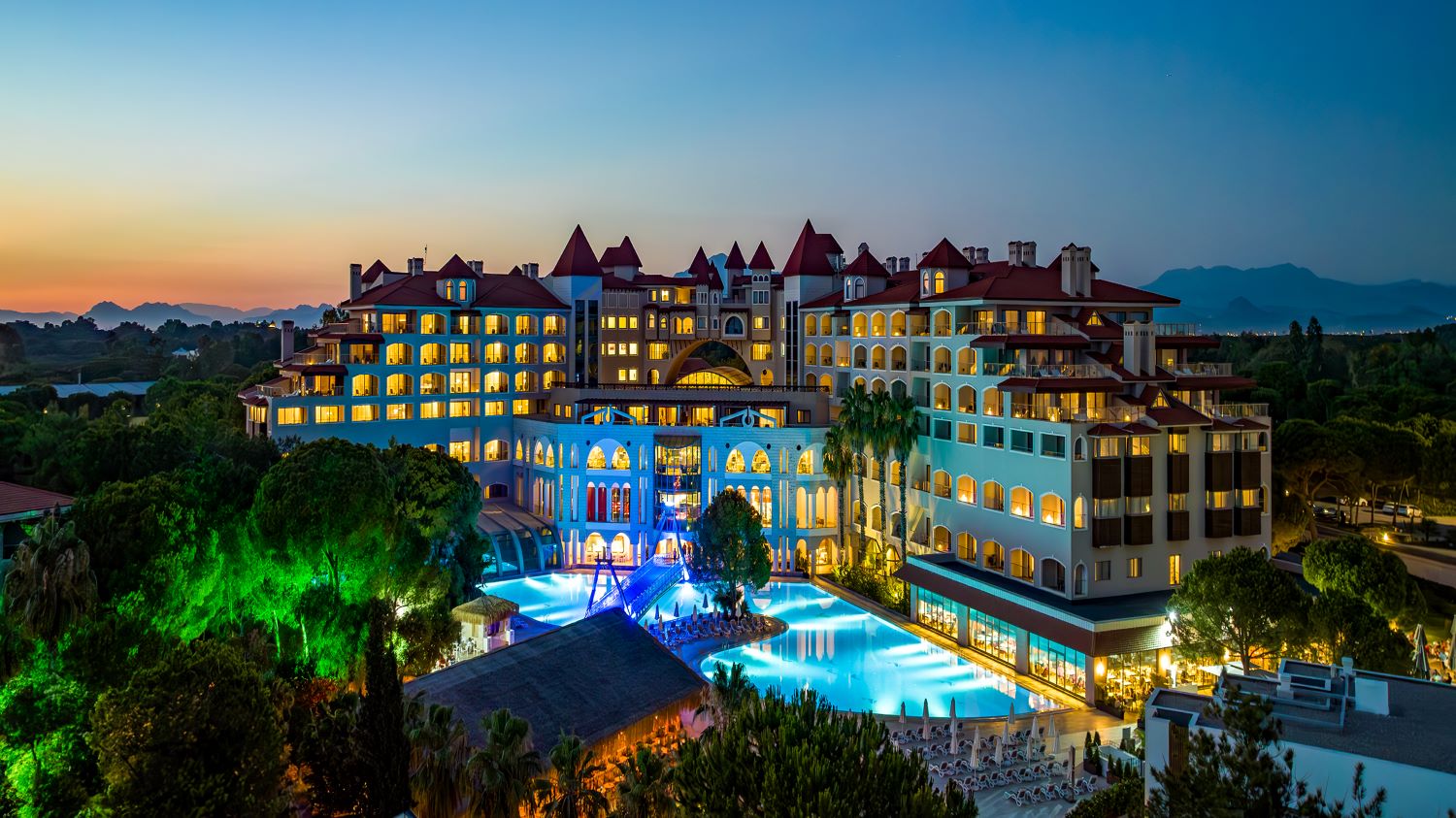 Sirene Golf Resort exterior at night