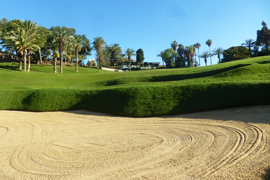 Bunker with sand and golf course in the background at Torrequebrada Golf Club in Costa Del Sol