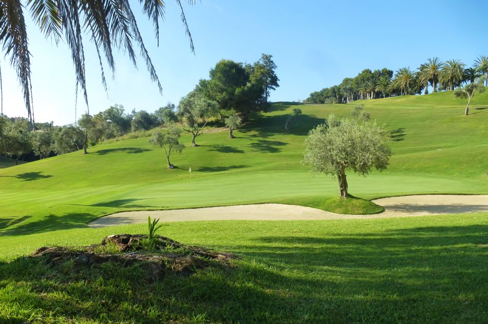 Blue sky over green golf course at Torrequebrada