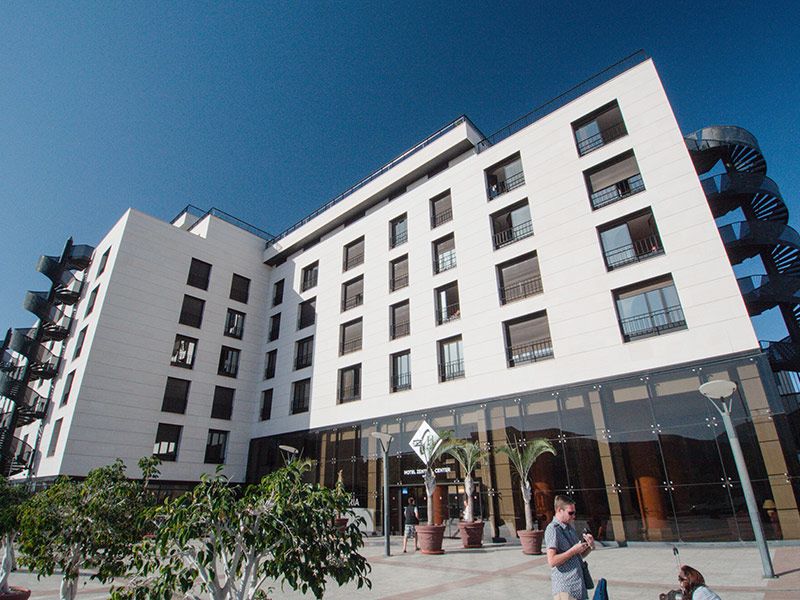 Outside of Zentral Center Hotel in Tenerife, with reception on the ground floor of white building