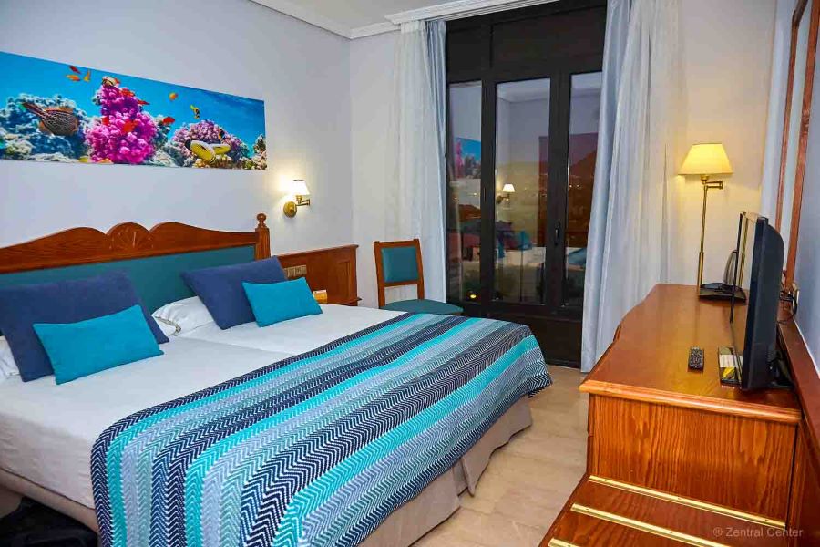 Smaller bedeoom with twin beds pushed together at Zentral Center Hotel