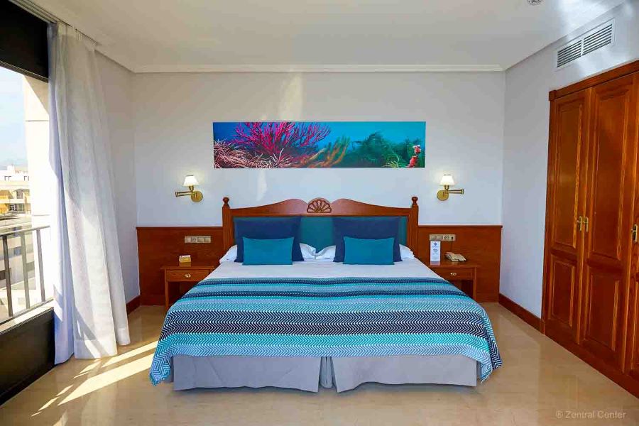 Bedroom with art on the wall at Zentral Centre Hotel in Tenerife