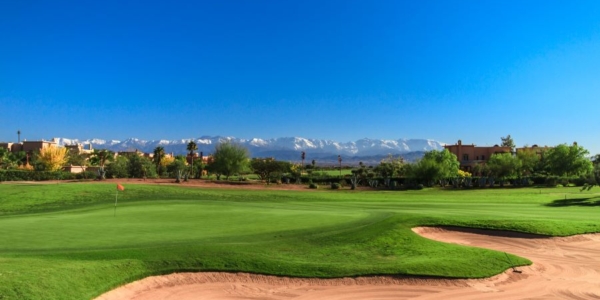 Golf Samanah in Marrakech with blue sky, green fairway and sandy bunker