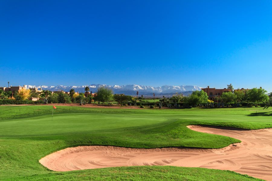 Golf Samanah in Marrakech with blue sky, green fairway and sandy bunker