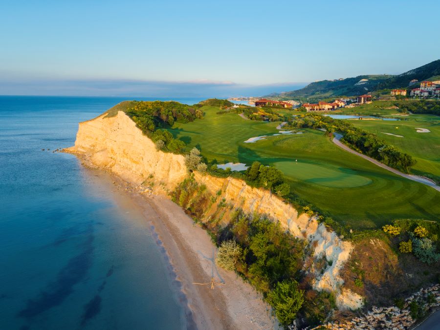 White cliffs with sandy beach below and golf course above at Thracian Cliffs