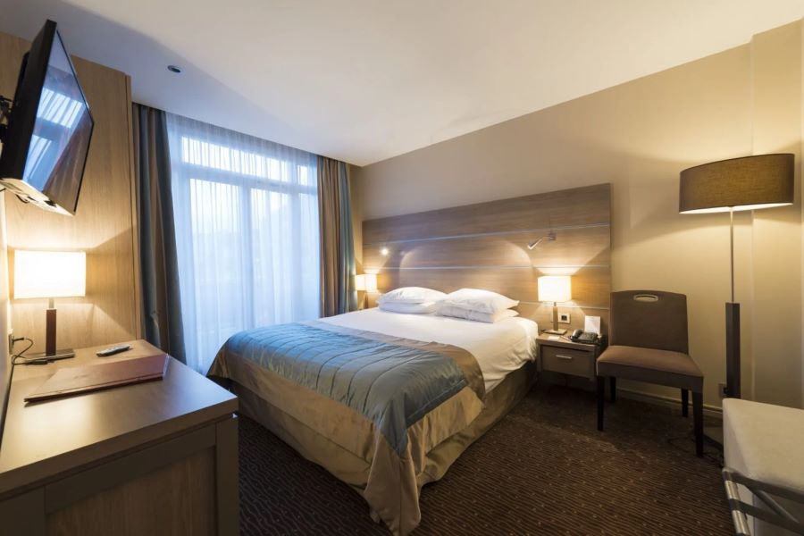 Double bed in bedroom with Hotel Bristol Le Touquet