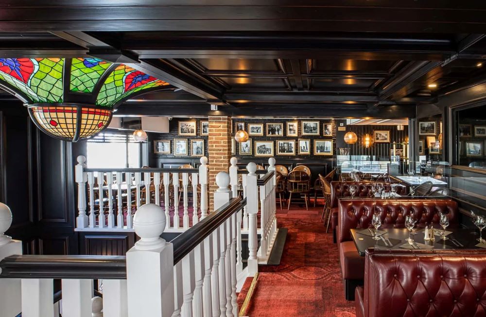 Red carpet in restaurant with white bannister at Hotel Bristol Le Touquet
