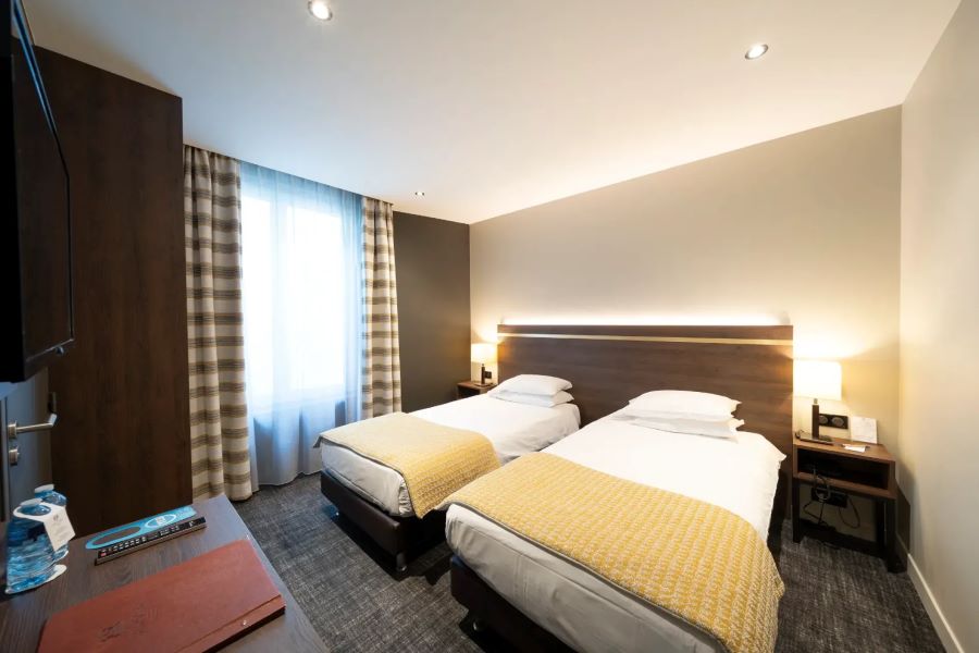 Twin beds in bedroom at Hotel Bristol Le Touquet