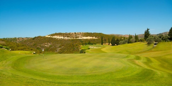 Green with white flag, and hills in the distance at Minthis Hills Golf Club in Paphos, Cyprus