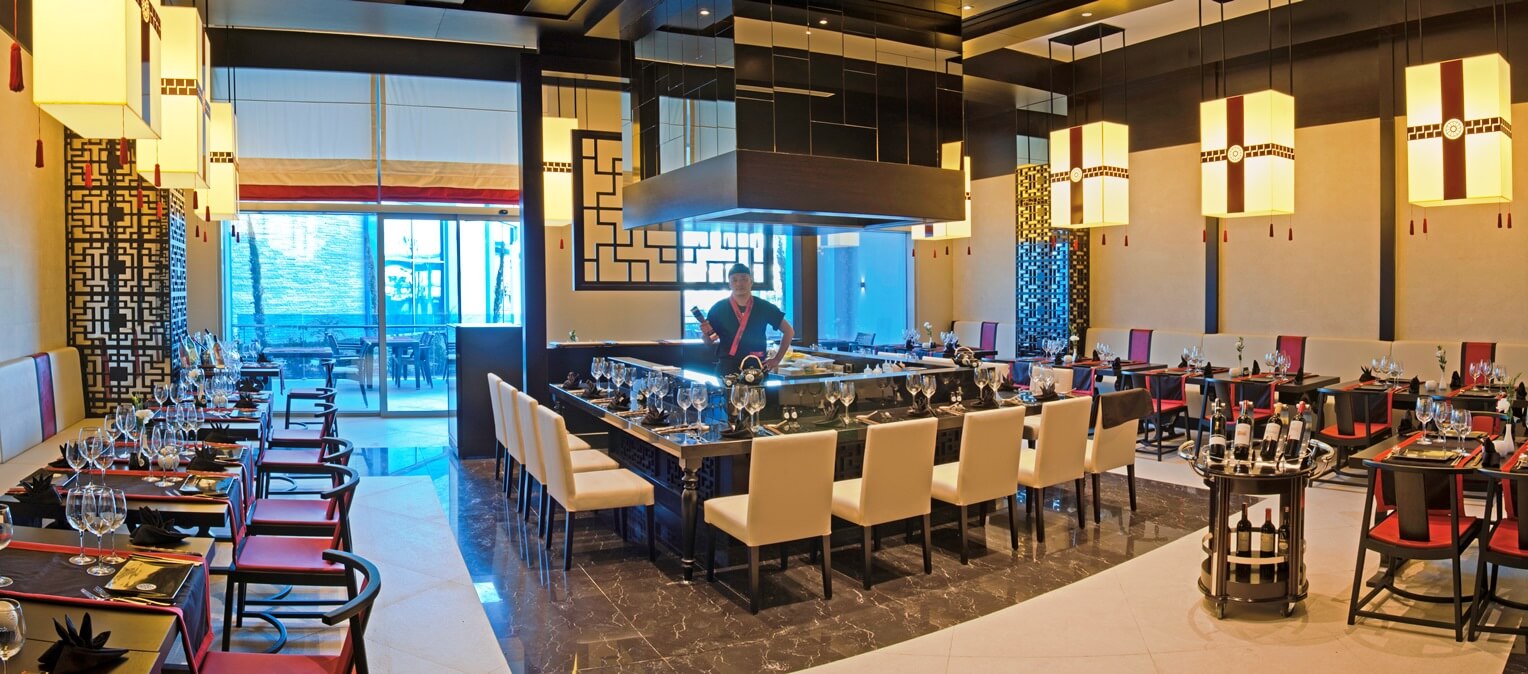 Chef in open kitchen of Japanese themed restaurant at Sueno Deluxe