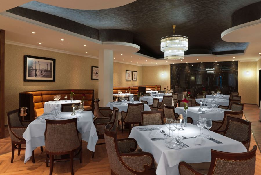 Seats and tables in restaurant at Alexander The Great Beach Hotel