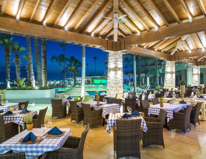 Outdoor dining area in authentic Greek style restaurant at Alexander The Great Beach Hotel