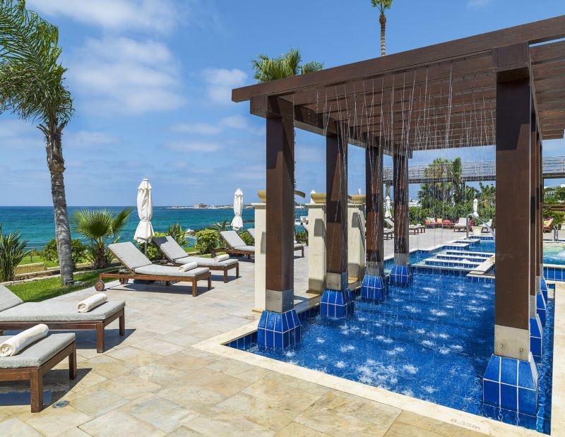 Sun loungers outside the outdoor pool area at Alexander The Great Beach Hotel in Paphos, Cyprus