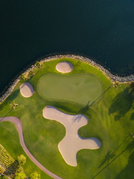 Dubai Creek Golf Club with arial shot of green surrounded by water