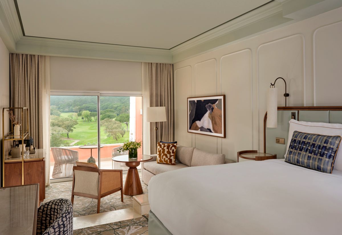 Bedroom with furniture and balcony at Penha Longa Resort in Lisbon