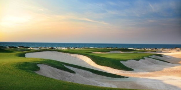 Bunkers with the sea in the distance at Saadiyat Beach Golf Club